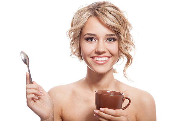 Young happy woman with an aromatic coffee in hands. Isolated