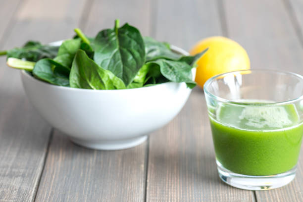 Fresh spring baby leaves of spinach on wood table.