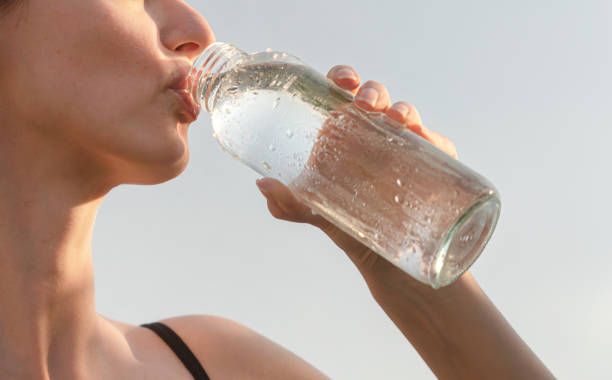 Woman drinking a fresh water from bottle
