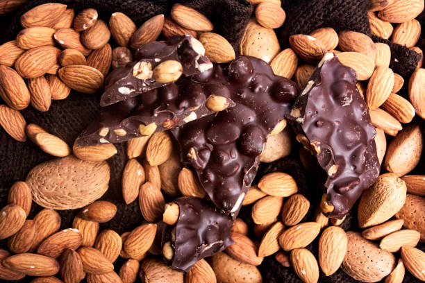 Chocolate with almonds top view background