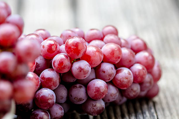 Red grape fruits on wooden