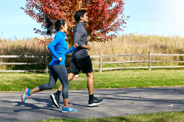 Shot of a sporty young couple exercising together outdoors