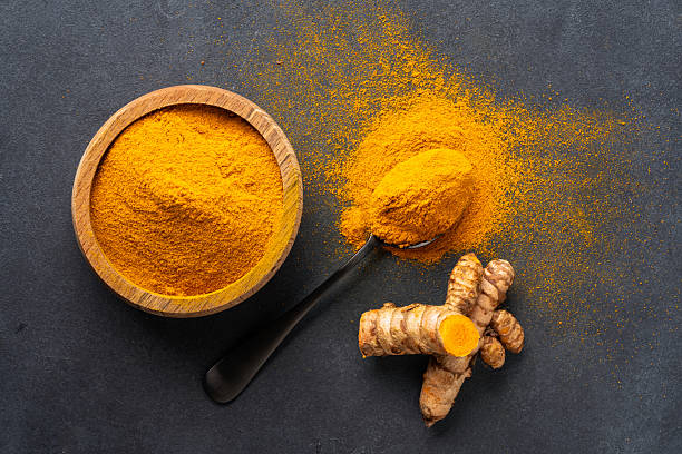 Turmeric with its magnificent orange color on a vintage black background