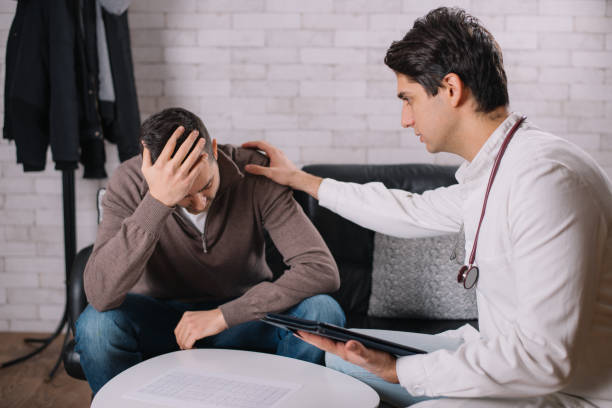 Doctor using tablet in front of a patient
