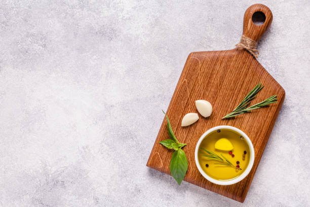 Herbs and condiments on light stone background. Top view with copy space.
