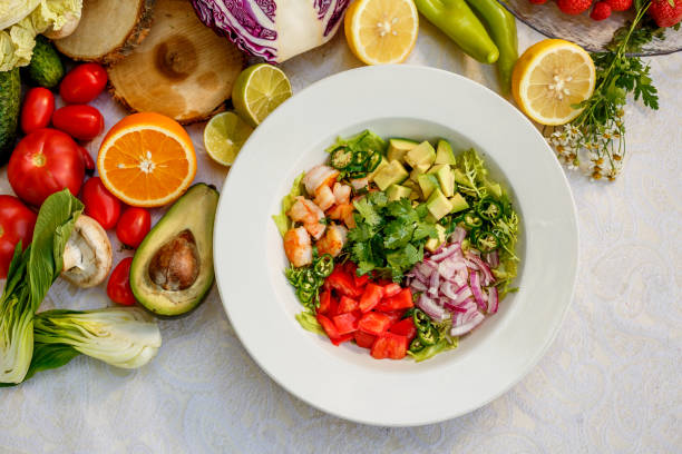 Salad with shrimps and vegetables, healthy food on the decorated table